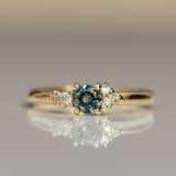 Asymmetric round sapphire parti cluster ring