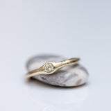 Raw ring with buried diamond