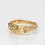 Wide Gold Band with Cracked Earth Texture and Buried Diamonds