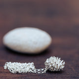 Silver pinecone set with stone necklace