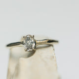 Raw engagement ring with oval diamond