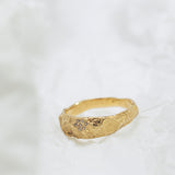Wide Gold Band with Cracked Earth Texture and Buried Diamonds