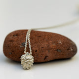 Silver pinecone set with stone necklace