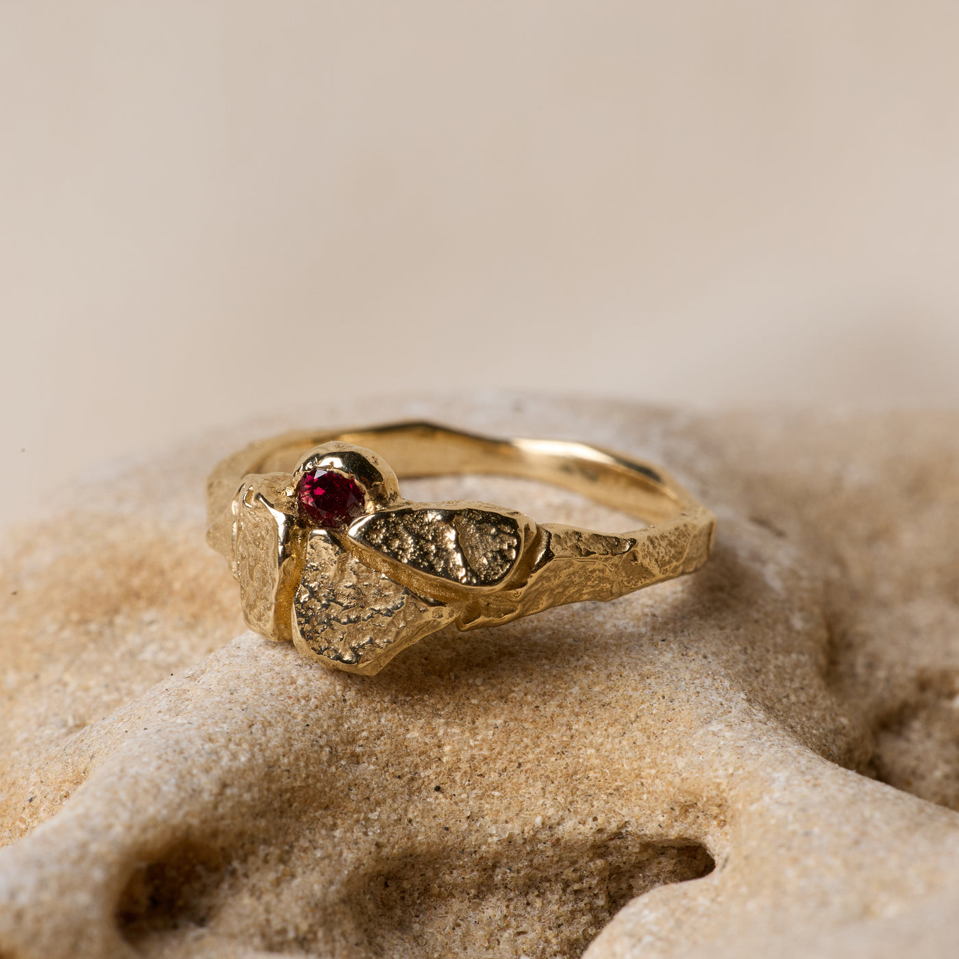 Bespoke organic gold ring with raw champagne diamond on limestone