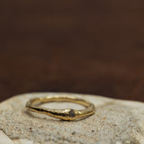 Raw diamond burried in raw gold ring