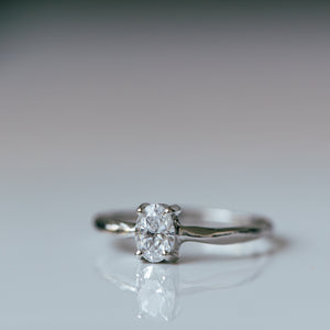 Raw white gold ring with oval white diamond