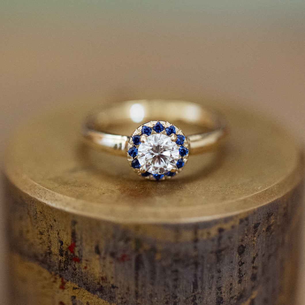 White diamond and blue sapphires halo ring