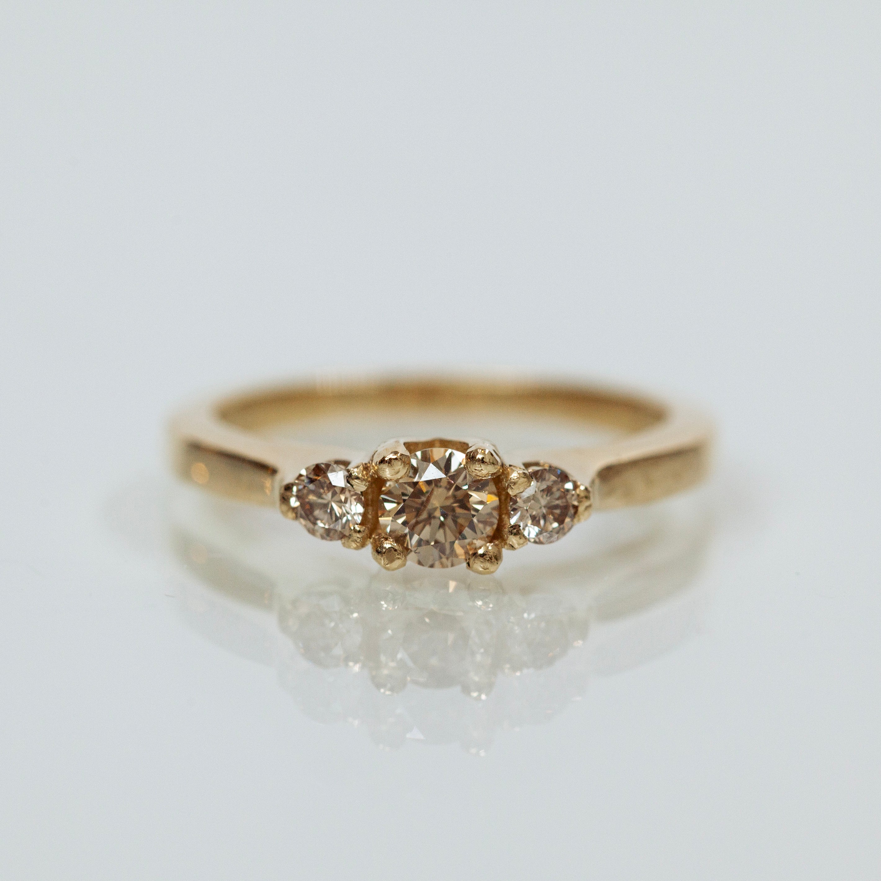 Champagne diamonds tri-stone ring