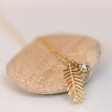 Palm tree leaf pendant with white diamond