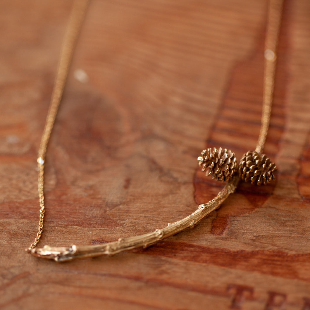 2 pincones on a branch necklace