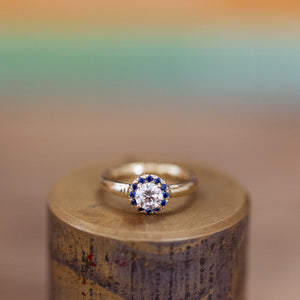 White diamond and blue sapphires halo ring