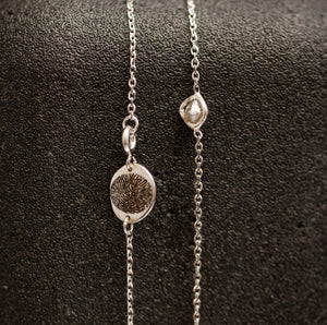 Rough diamond with a finger-print necklace