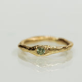 Raw gold ring with green sapphire