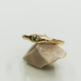 Raw gold ring with green sapphire