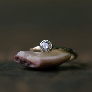 Raw gold ring with bezel champagne setting
