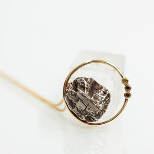 Meteorite in a round pendant
