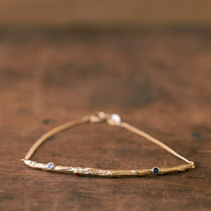 Thick gold banch bracelet with gems